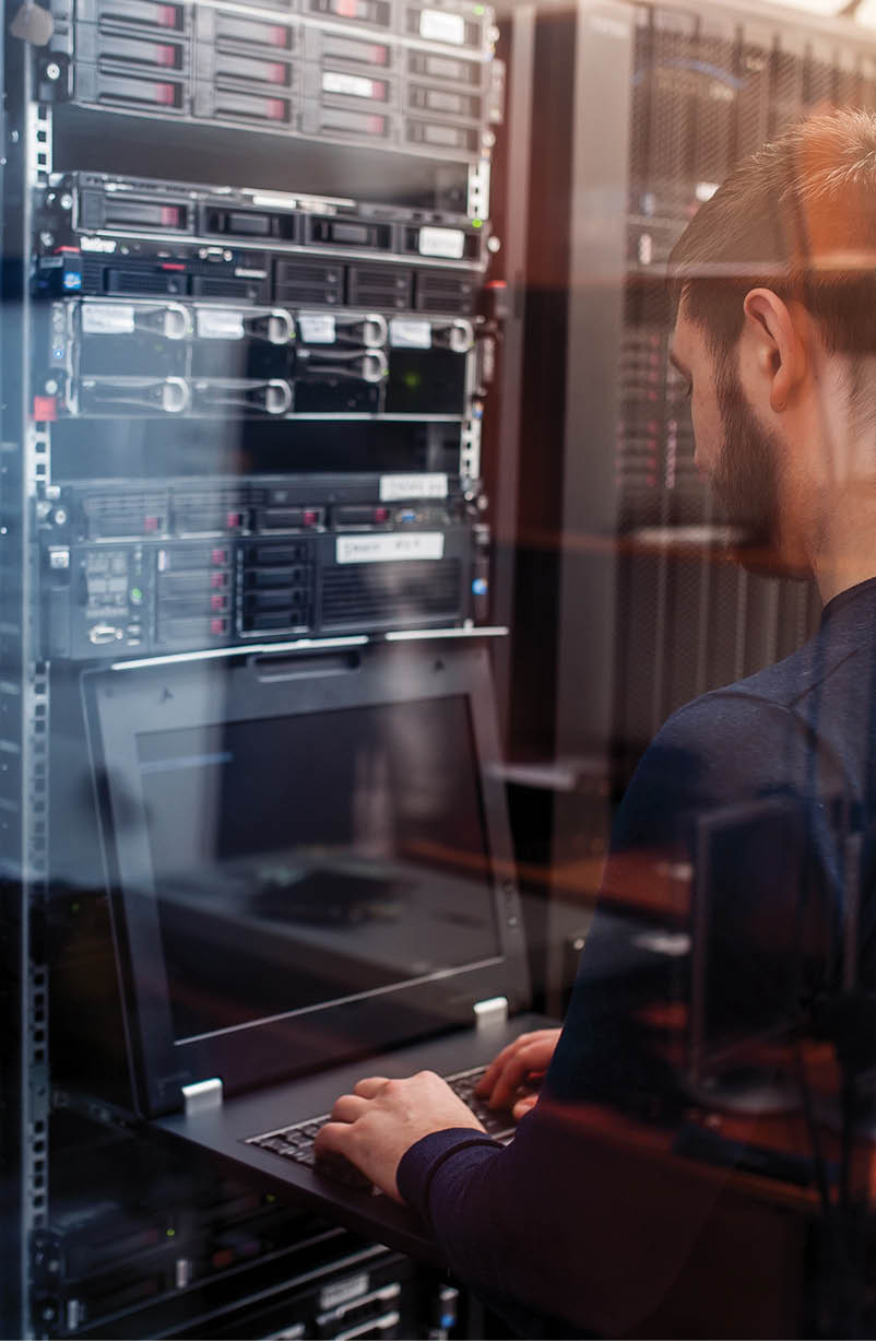 young it engeneer business man with thin modern aluminium laptop in network server room